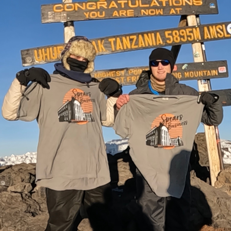Bryson Wolfe and Ben Simpson, OSU students, hold Spears School of Business T-shirts at the top of Mount Kilimanjaro.
