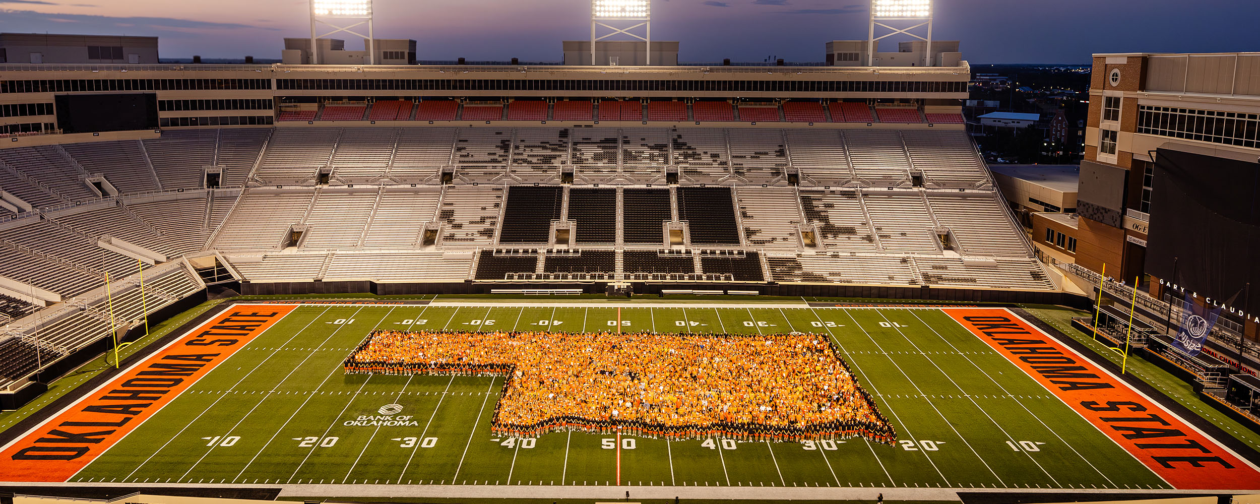 The Class of 2029 Students form a shape of the state of Oklahoma inside Boone Pickens Stadium.