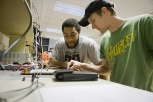 Students work on electrical wiring.