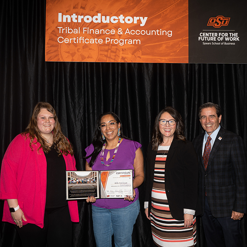 A participant smiles with their certificate of completion from the CFW's eight-week Tribal Finance and Accounting program.