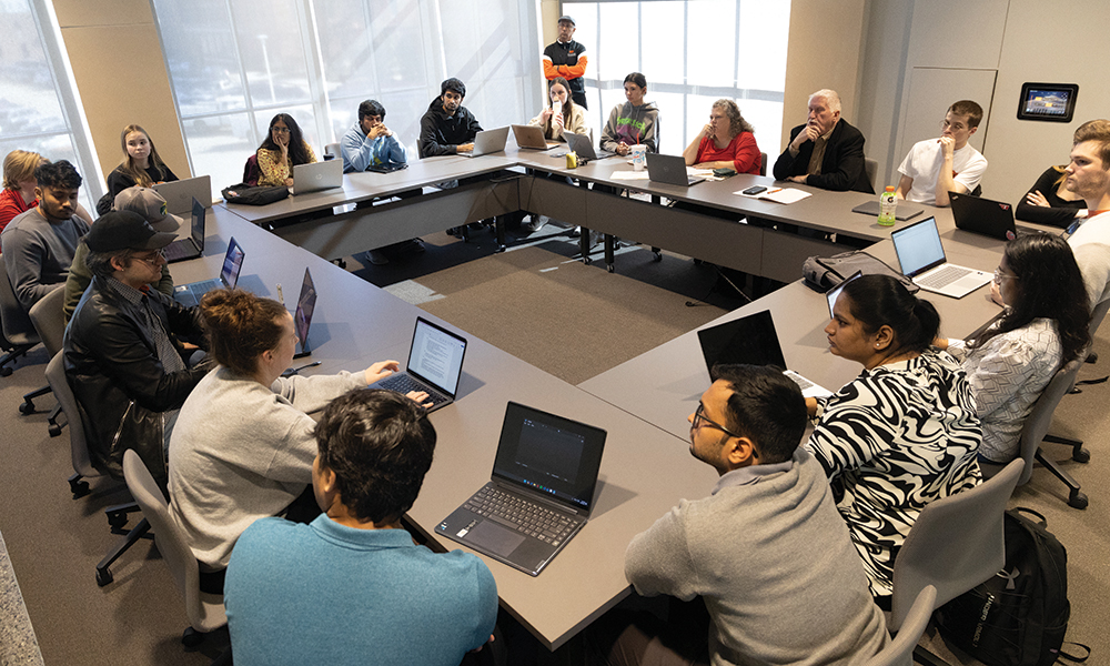 MS BAnDS students sit around a conference room table.