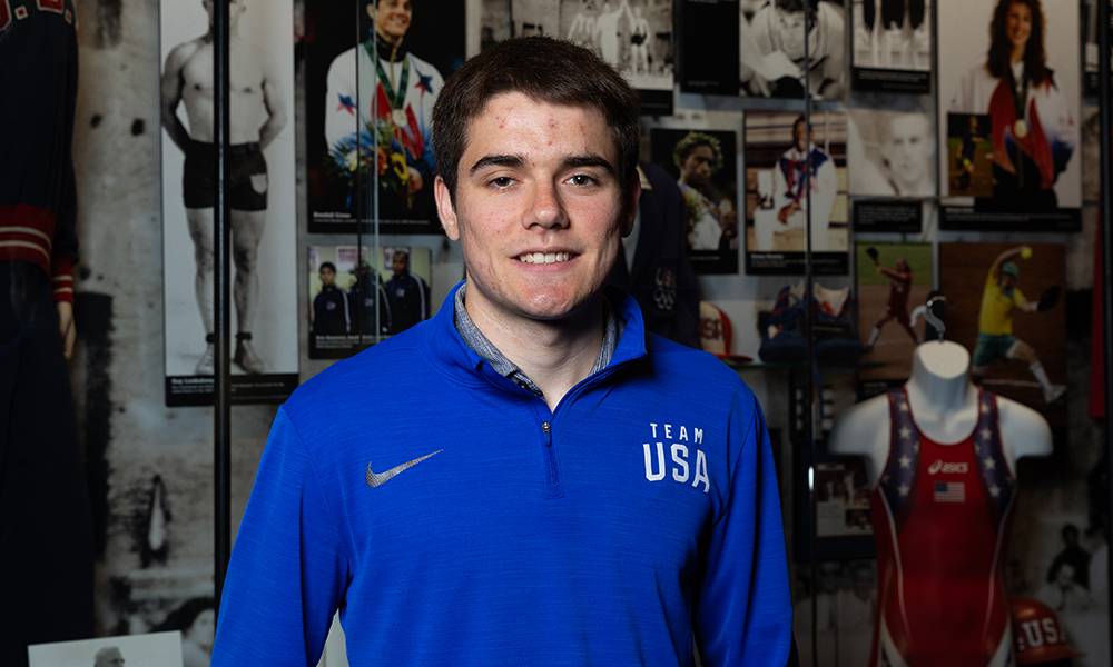 Josh Malcom smiling in Gallagher-Iba Arena's Heritage Hall.