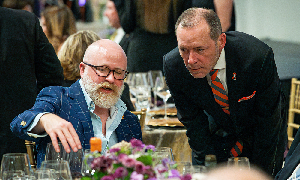 A vintner speaks with a Wine Forum guest about his selection.