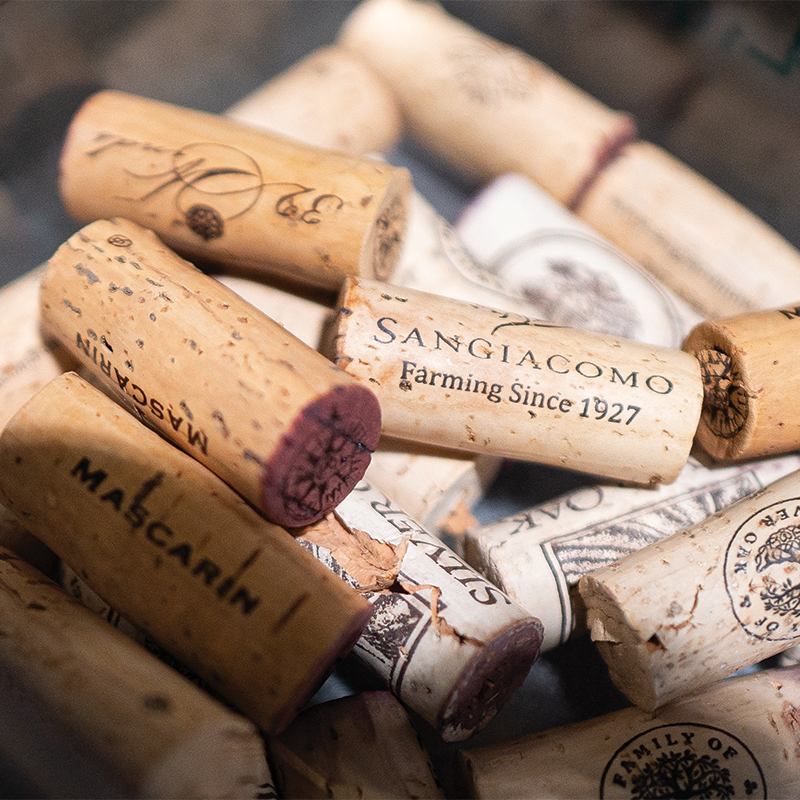 A collection of corks from the Wine Forum bottles in a glass.
