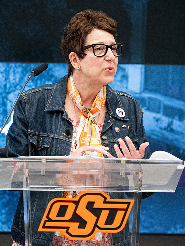 The keynote speaker of the Wine Forum of Oklahoma speaking at the podium.