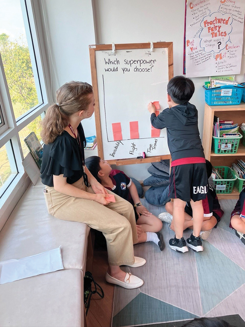 OSU student teaching intern Madeline Hager worked with students in an interactive bar graph activity.