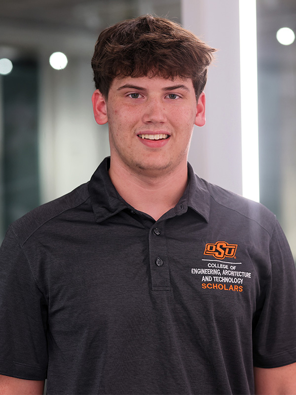 Student smiling wearing a black CEAT scholars polo