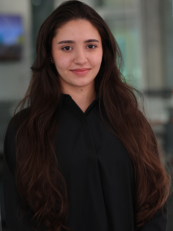 Student smiling in black blouse