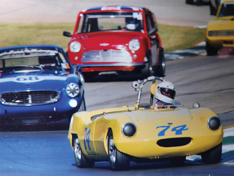 An older photo from the 1970s of racecars in a race.