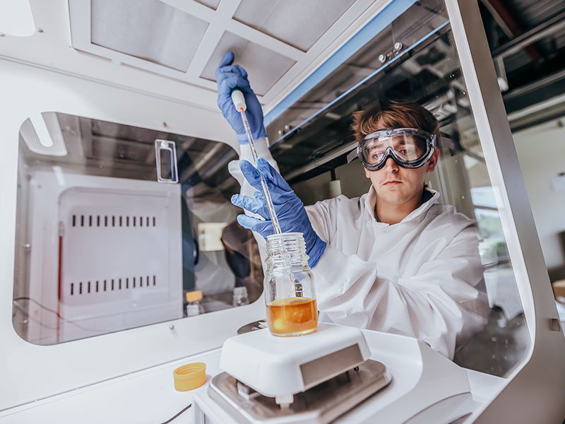Reese Huhnke, OSU NPDC intern and CHE student, does chemical testing the the ParaNano laboratory