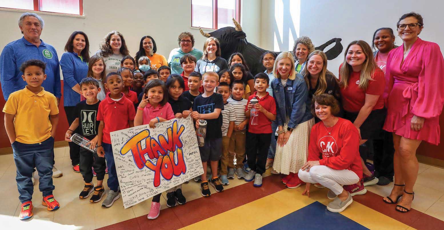 C4K provided running shoes for every Cesar Chavez Elementary student in the 2022 OKC Memorial Kids Marathon. Five volunteers and staff pictured are OSU graduates. From right: Stacy McDaniel, Rosalyn Robinson, Meredith Tatum (C4K programs director), Lauren Stoll Webb, and Allyson Cain Meyer (C4K deputy director).